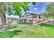 Ranch style home with landscaped yard, detached garage, and spacious backyard at 7475 W Kentucky Ave, Lakewood, CO 80226