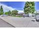 Ranch-style home with a fenced yard, driveway, and mature trees at 7475 W Kentucky Ave, Lakewood, CO 80226