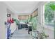 Sunlit home office with built-in desk and abundant plants at 7475 W Kentucky Ave, Lakewood, CO 80226