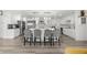 Modern kitchen with white cabinets, large island, and stainless steel appliances at 7475 W Kentucky Ave, Lakewood, CO 80226