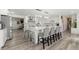 Modern kitchen with white cabinetry, large island, and stainless steel appliances at 7475 W Kentucky Ave, Lakewood, CO 80226