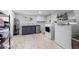Basement laundry room with washer, dryer, and ample storage at 7475 W Kentucky Ave, Lakewood, CO 80226
