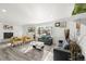 Open concept living area with a fireplace and plenty of natural light at 7475 W Kentucky Ave, Lakewood, CO 80226