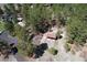 Aerial view of outbuilding with fenced yard, surrounded by mature trees at 1559 Apex Rd, Franktown, CO 80116