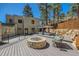 Outdoor living area with a fire pit, lounge seating, and lush landscaping with a hot tub at 1559 Apex Rd, Franktown, CO 80116