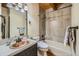 Unique bathroom featuring a copper sink, built in tub and shower with a tiled wall at 1559 Apex Rd, Franktown, CO 80116