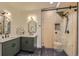 Stylish bathroom featuring dual sinks, modern fixtures, a walk-in shower with sleek glass doors at 1559 Apex Rd, Franktown, CO 80116