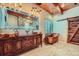 Rustic bathroom with a copper soaking tub, wooden vanity with vessel sinks, and stylish lighting fixtures at 1559 Apex Rd, Franktown, CO 80116