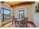 Cozy dining room featuring a rustic round table with seating for four and scenic outdoor views at 1559 Apex Rd, Franktown, CO 80116