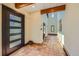 Bright and spacious foyer features tile flooring, high ceilings, and a modern front door at 1559 Apex Rd, Franktown, CO 80116
