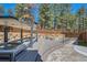 Outdoor hot tub and lounge seating area with a fire pit and wooded views at 1559 Apex Rd, Franktown, CO 80116