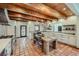 Bright kitchen showcasing an island table, stainless steel appliances, and sleek white cabinets at 1559 Apex Rd, Franktown, CO 80116