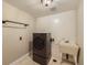 Updated laundry room with modern washer and dryer, utility sink, and ample space at 1559 Apex Rd, Franktown, CO 80116