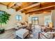 Spacious living room with wood ceilings, a comfortable sofa, and large windows offering scenic views at 1559 Apex Rd, Franktown, CO 80116