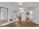 Bonus room featuring wood floors, multiple mirrors, and white trim at 10345 Lions Heart, Lone Tree, CO 80124