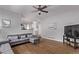 Open living room features wood floors and gray sofa at 10345 Lions Heart, Lone Tree, CO 80124