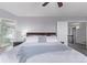Bright main bedroom showcasing a plush bed, a gray accent pillow and a light blue throw blanket at 10345 Lions Heart, Lone Tree, CO 80124