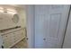 Bathroom featuring a vanity with a granite countertop, complemented by a bi-fold closet at 100 E Highline Cir # 307, Centennial, CO 80122