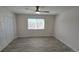 Bedroom featuring a window with blinds, wood-look floors, and a sliding door closet at 100 E Highline Cir # 307, Centennial, CO 80122