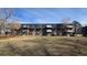 A multi-Gathering brick apartment building with balconies surrounded by a lawn and trees at 100 E Highline Cir # 307, Centennial, CO 80122