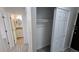Bright hallway with a linen closet and bathroom featuring a vanity and a round mirror at 100 E Highline Cir # 307, Centennial, CO 80122