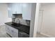 Modern kitchen with sleek countertops, stainless steel appliances, and white cabinetry at 100 E Highline Cir # 307, Centennial, CO 80122