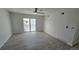 Bright living room featuring wood-look floors, ceiling fan, and sliding glass doors to outdoor space at 100 E Highline Cir # 307, Centennial, CO 80122