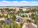 Expansive aerial view of multiple homes surrounded by lush trees with distant views at 1330 Conifer Pl, Elizabeth, CO 80107