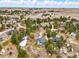 Scenic aerial view of various homes nestled among dense trees with expansive landscape beyond at 1330 Conifer Pl, Elizabeth, CO 80107