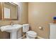 Stylish powder room with a pedestal sink and classic fixtures at 1330 Conifer Pl, Elizabeth, CO 80107