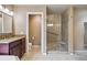 Bathroom with a glass shower and seat, granite counters, and wood cabinets at 1330 Conifer Pl, Elizabeth, CO 80107