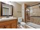 Bathroom featuring a glass-enclosed shower, a white toilet and tile flooring at 1330 Conifer Pl, Elizabeth, CO 80107