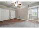 Bedroom with neutral-colored walls, carpet, ceiling fan, and ample closet space at 1330 Conifer Pl, Elizabeth, CO 80107