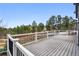 Deck overlooking lush green trees with black and white railings at 1330 Conifer Pl, Elizabeth, CO 80107