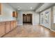 Open dining room area with doors to the outside, tile flooring, and built in wooden cabinetry at 1330 Conifer Pl, Elizabeth, CO 80107