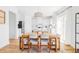 Stylish dining area with a wood table, white cabinets, and a view of the kitchen at 9542 Cherry St, Thornton, CO 80229