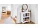 Inviting entryway featuring wood floors, a small bookshelf, and a round mirror at 9542 Cherry St, Thornton, CO 80229