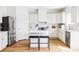 Modern kitchen featuring white cabinets, stainless steel appliances, and a center island at 9542 Cherry St, Thornton, CO 80229