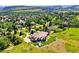 Elegant home with an in-ground pool, hot tub, lush greenery, and stunning panoramic views of the surrounding landscape at 13 Tamarade Dr, Littleton, CO 80127