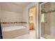 Relaxing bathroom featuring a luxurious soaking tub and a tiled walk-in shower at 13 Tamarade Dr, Littleton, CO 80127