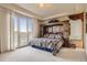 Bedroom featuring a decorative headboard, neutral carpeting, and a balcony with mountain views at 13 Tamarade Dr, Littleton, CO 80127