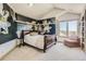 Stylish bedroom with a mural accent wall, plush carpeting, and a serene window view at 13 Tamarade Dr, Littleton, CO 80127