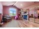 Bonus room featuring a fireplace, built in shelving, light hardwood floors, and a large window at 13 Tamarade Dr, Littleton, CO 80127