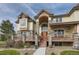 Charming two-story home with stone accents, a welcoming porch, and beautiful landscaping at 13 Tamarade Dr, Littleton, CO 80127