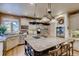 Well-equipped kitchen featuring a large island, stainless steel appliances, and mountain views through the window at 13 Tamarade Dr, Littleton, CO 80127