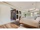 Inviting main bedroom with a fireplace, tray ceiling, and large windows providing natural light at 13 Tamarade Dr, Littleton, CO 80127