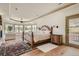 Spacious main bedroom featuring a tray ceiling, large windows, and outdoor access at 13 Tamarade Dr, Littleton, CO 80127