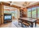 Wood-paneled office with fireplace, large windows, custom desk, and mountain views at 13 Tamarade Dr, Littleton, CO 80127