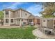 Backyard with a patio, playset, and manicured lawn at 4220 S Yarrow Ct, Lakewood, CO 80235