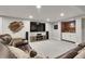Finished basement area with a large TV, cozy seating, and a wet bar for entertaining at 4220 S Yarrow Ct, Lakewood, CO 80235